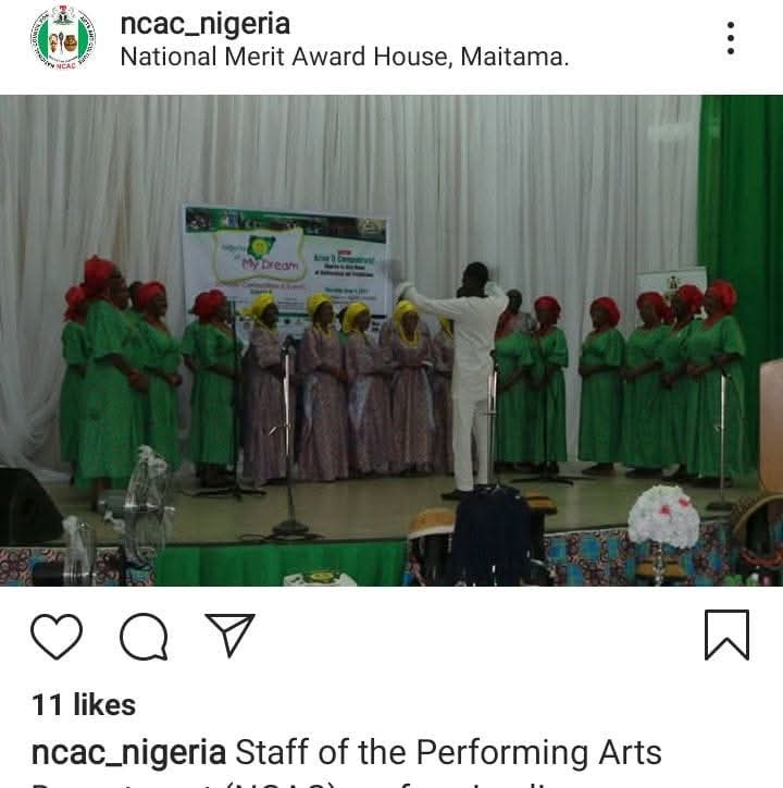 Choir performing with a conductor on stage